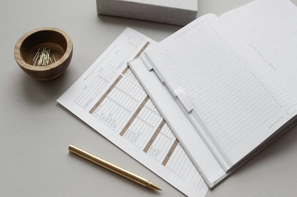 Person reviewing loan documents with calculator and notepad, focused on debt consolidation plan