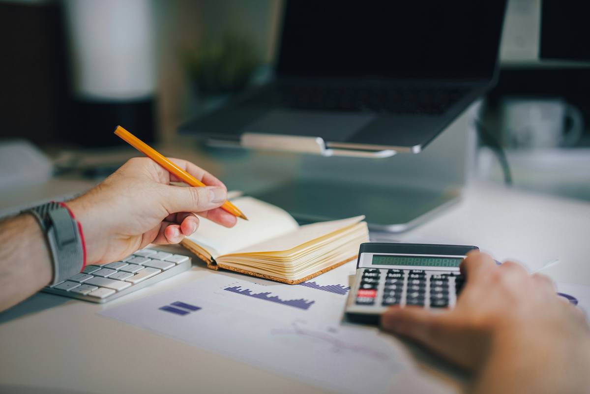 top debt consolidation management showing a person organizing bills into one payment plan